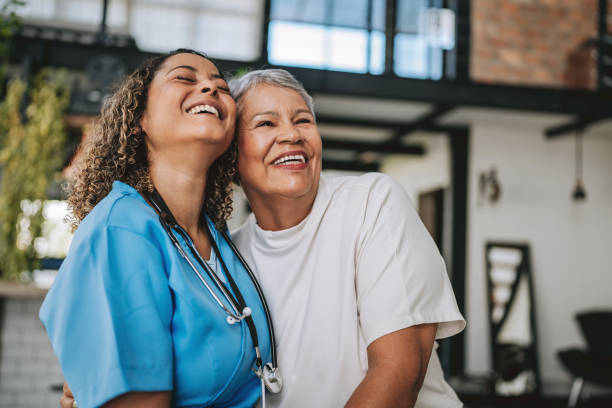 Home care healthcare professional hugging elderly patient
