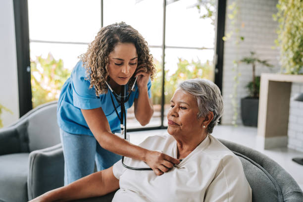 istock Home care healthcare professional using stethoscope 2200416600