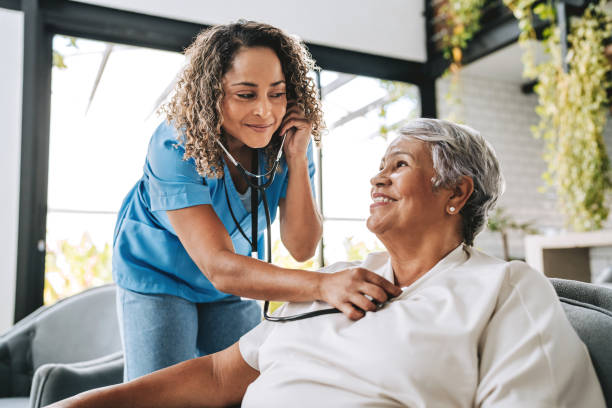 istock Home care healthcare professional using stethoscope 2200416606