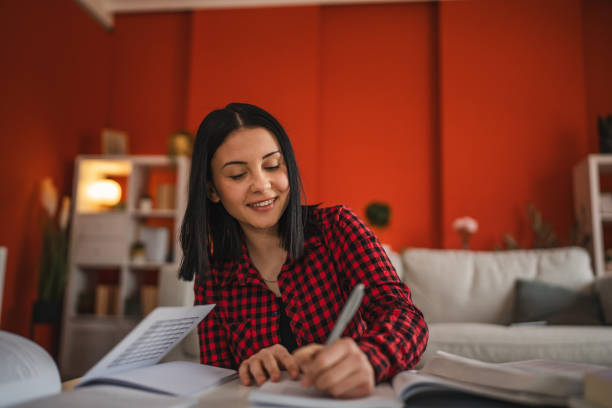 istock focused high school girl study and prepare exams at home 2200418094