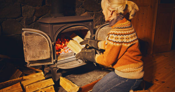 istock Woman filling stove 2200418896