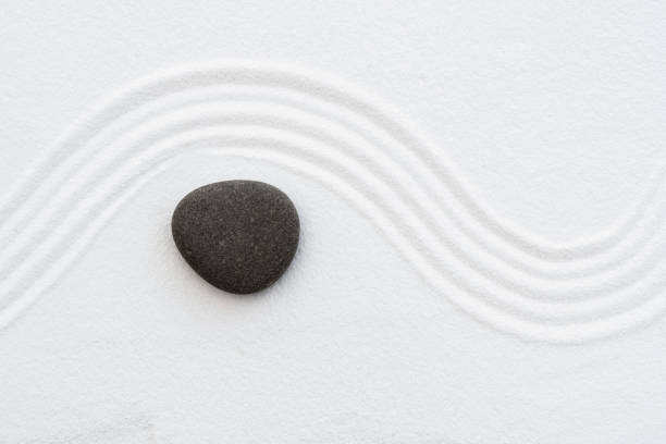istock Zen Garden with Grey Stone on White Sand 2200419057