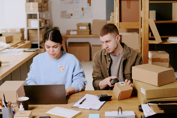 istock Team Working in an Office with Shipping Boxes 2200420790