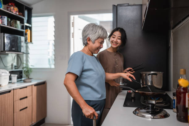 istock Daughter helps mother make lunch 2200421630