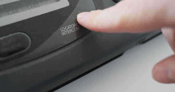 istock Close-up, finger pressing locator intercom button on an old fax machine, analog transmission of information. Concept of search for telephone handset, device on the network. 2200423734