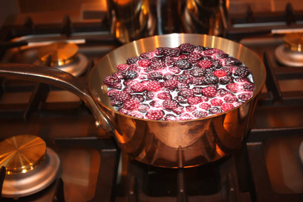 istock Blackberry jam cooking in a copper pan 2200424251