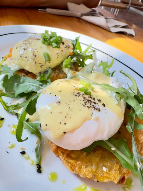 istock Egg Benedict on a plate standing on a wooden table 2200424365