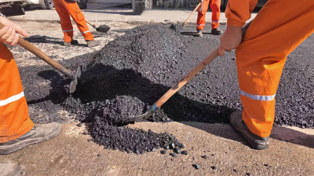 istock Construction workers working on a new asphalt layer on a public street. 2200426613