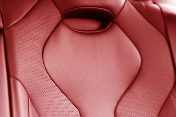 istock Back passenger black seats in modern luxury car. Red perforated leather with white stitching. Car details. Leather comfortable seats. Car interior details 2200426712