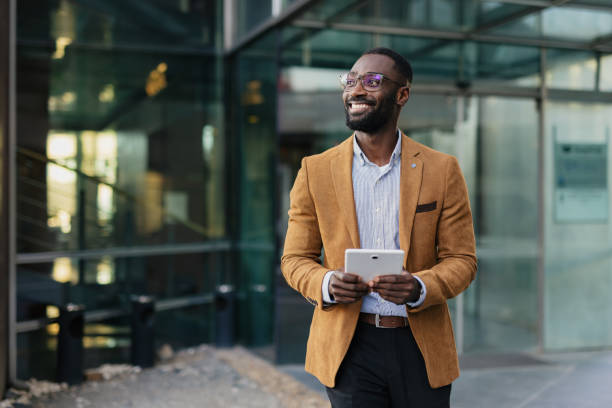 istock Confident Businessman Holding Tablet in Urban Setting 2200428684