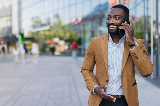 istock Confident Businessman Talking on Mobile Phone Outdoors 2200428687