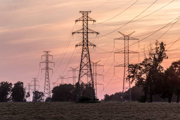 istock Power lines silhouetted against a sunset sky. 2200428925