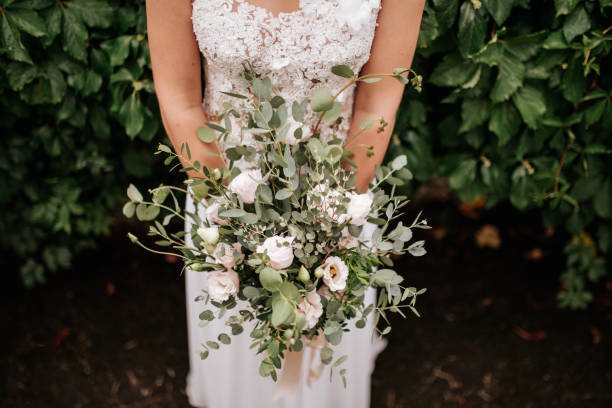 istock Bride Holding a Lush Green and White Wedding Bouquet 2200429601