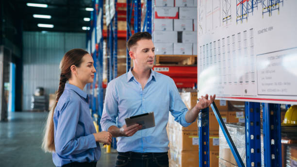 istock Warehouse worker working and checking the stock in the warehouse. .Factory manager using digital tablet check barcode in industry factory logistic. 2200429727
