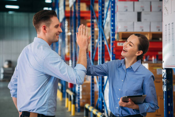 istock Warehouse worker stack hand and shake hands to show success in the warehouse. Worker industry join hand for collaboration. 2200429762