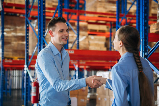 istock Warehouse worker stack hand and shake hands to show success in the warehouse. Worker industry join hand for collaboration. 2200429782