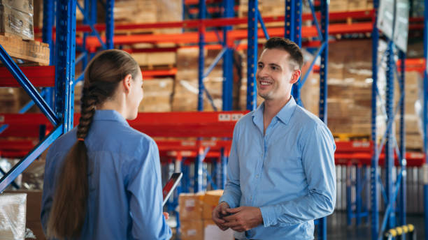Warehouse worker working and checking the stock in the warehouse. .Factory manager using digital tablet check barcode in industry factory logistic.