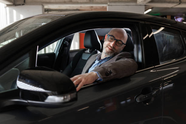 istock Man sitting in a car in a parking garage 2200431797