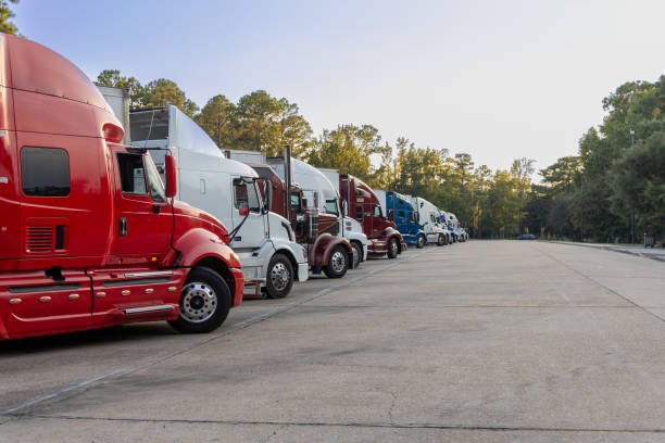 istock A row of parked semi trucks in a lot. 2200432448