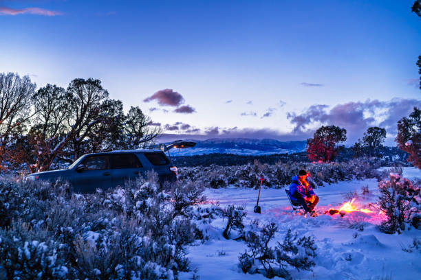 istock Man Winter Car Camping in Snow 2200432941
