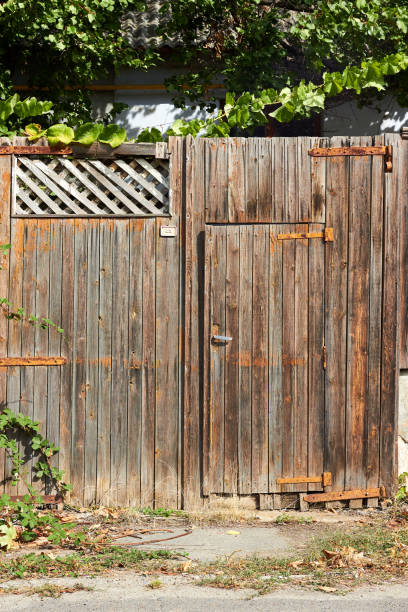 istock Old wooden fence and closed wicket 2200433319