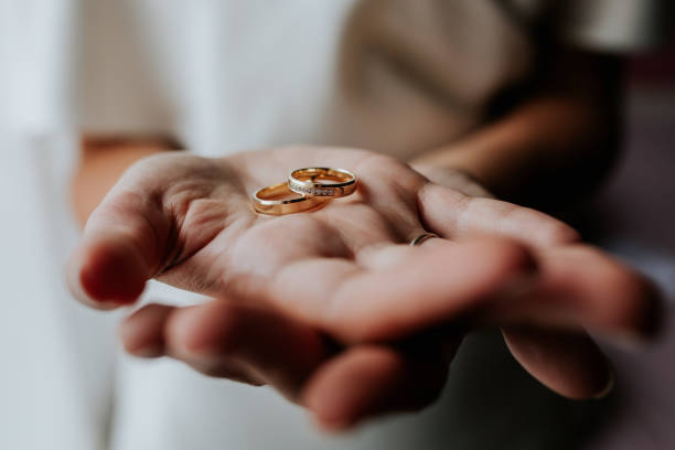 istock Bride Holding Wedding Rings in Open Hands 2200438336