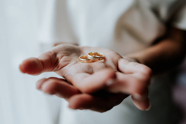 istock Bride Holding Wedding Rings in Open Hands 2200438349