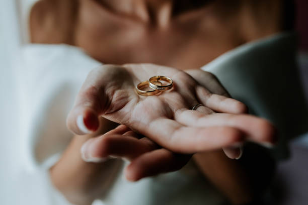 istock Bride Holding Wedding Rings in Open Hands 2200438357