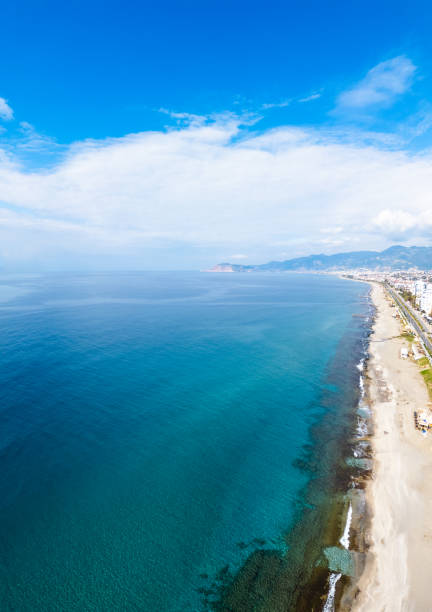 istock An aerial perspective captures the expansive ocean sparkling under bright sunlight, with a clear blue sky 2200443815
