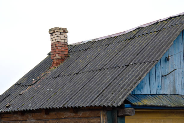 istock The brick chimney on the roof is in poor condition. 2200445677