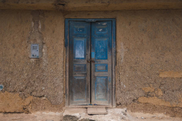 istock Closed door in an aged adobe wall 2200446271