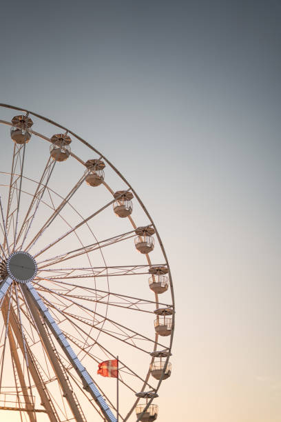istock Ferris wheel at sunset in Biscarrose 2200446961