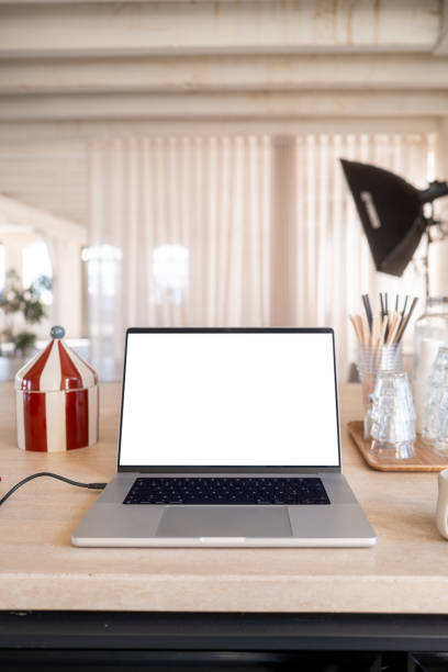 istock Cozy home office setup with laptop and coffee mug on desk 2200448351