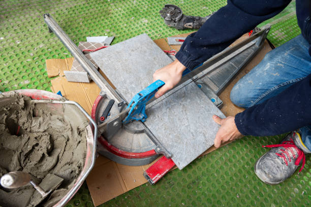 istock Tiler at work installing new floor with tiles. Construction. 2200448712