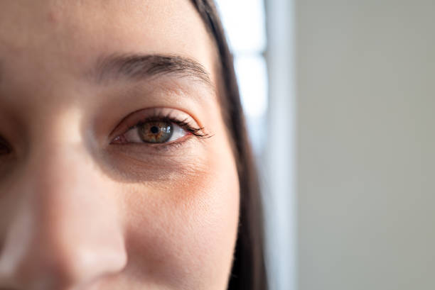 istock Young woman staring with hazel eye close-up, expressing confidence and focus 2200449214