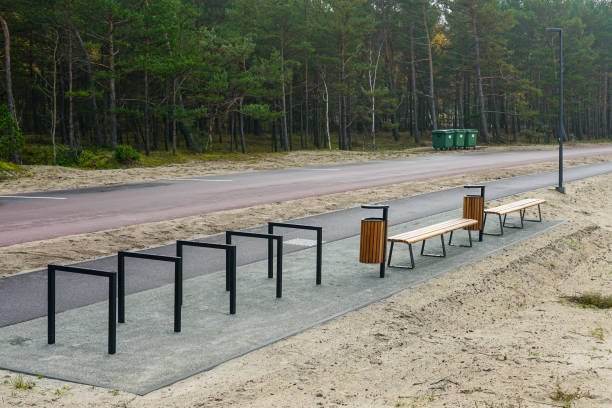 Contemporary ecological seaside environmental development, bike path, wooden benches, trash cans