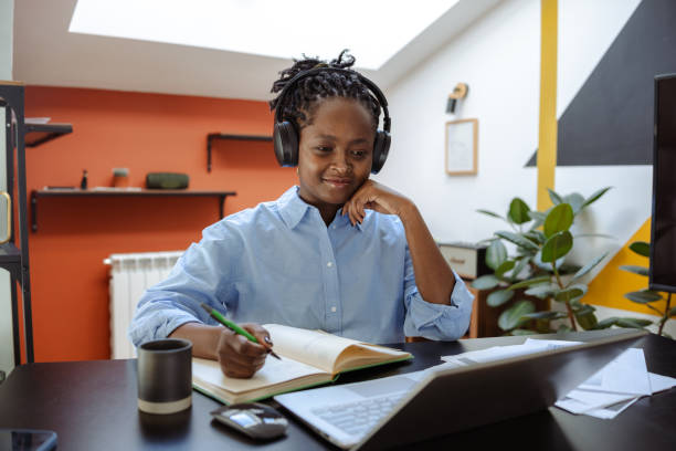 istock Professional young woman engaging in an online meeting while working from home 2200451580