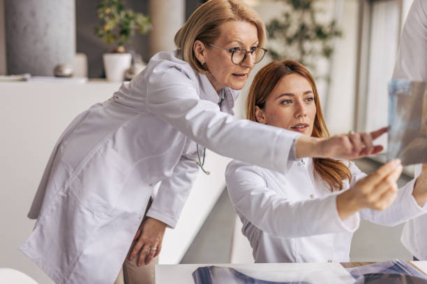istock Two female doctors examining x-ray in hospital 2200451963