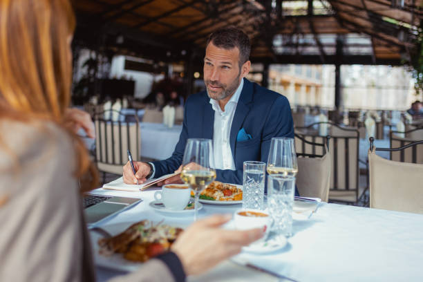 Entrepreneurs Discussing Startups Over Gourmet Dishes