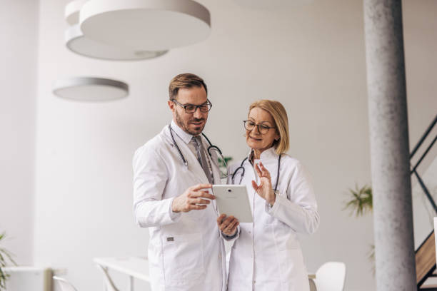 istock Doctors using digital tablet are discussing patient's medical history in hospital 2200453700