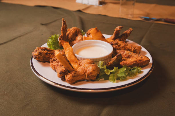 istock Fried chicken served with condiments on a plate on a tablecloth. 2200455742