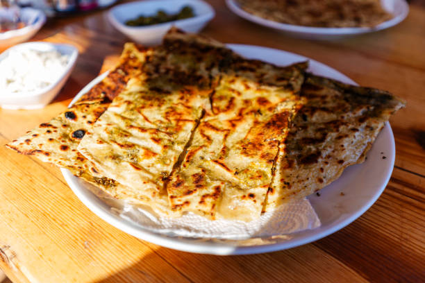 istock Delicious Flatbread Lahmacun Turkish Dish Served on Wooden Table with Appetizing Sides 2200456036