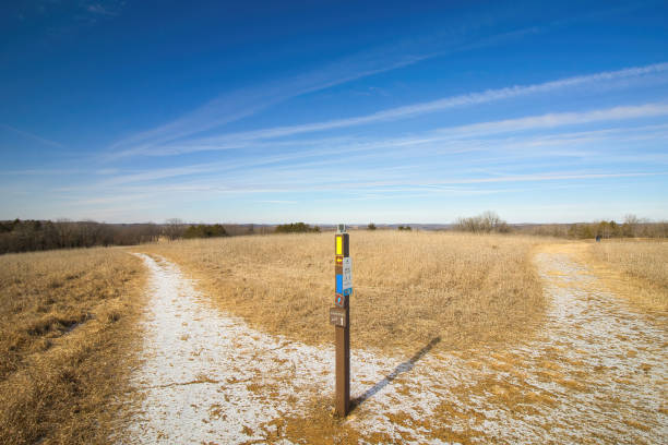Cross Plains, Wisconsin, USA – February 11, 2025: Winter day landscape of a marker on a hilly field for the Cross Plains Segment of the Ice Age Trail, near Cross Plains, Wisconsin.