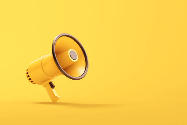 istock Single yellow electric megaphone with a handle stands on a yellow background 2200459979