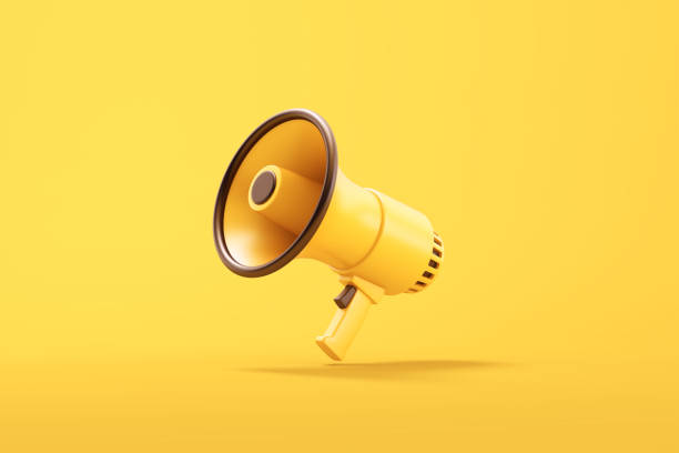 istock Single yellow electric megaphone with a handle stands on a yellow background 2200459980