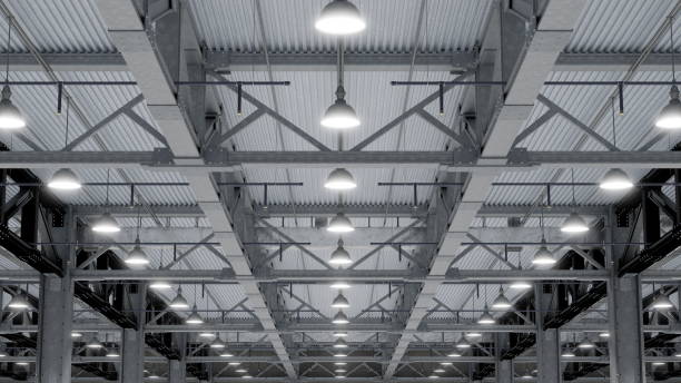 istock Bright overhead lights illuminate an industrial warehouse with high ceilings and exposed metal beams. 3d render 2200463913