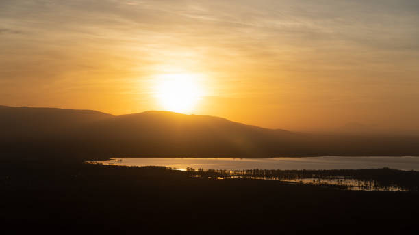 istock The Stunning Sunset Over Rolling Hills and Reflective Water Creates a Captivating Atmosphere Lake Manyara Tanzania Africa 2200469026