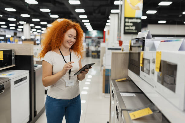Woman chooses laptop computer in shop