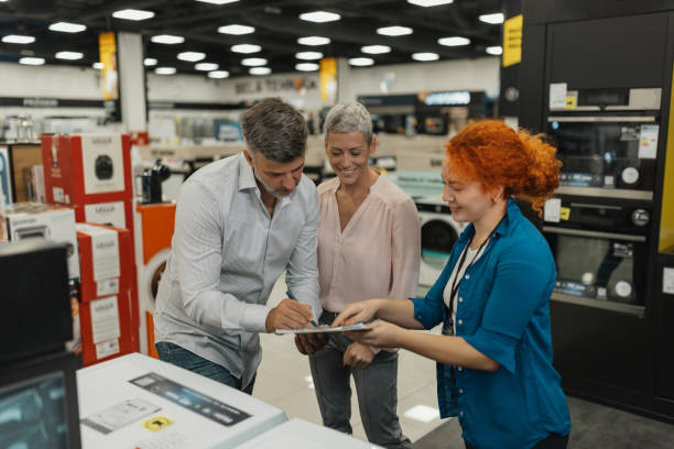 istock Couple Enjoying Interaction with Sales Associate 2200476417