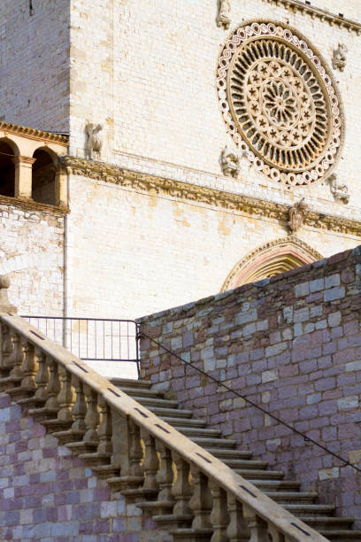 Assisi, Italy: The outside of the rose window and a staircase of the Upper Basilica of St Francis of Assisi. The landmark church is located in Umbria, province of Perugia.